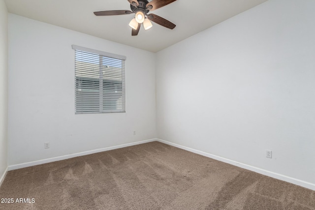 spare room featuring ceiling fan and carpet