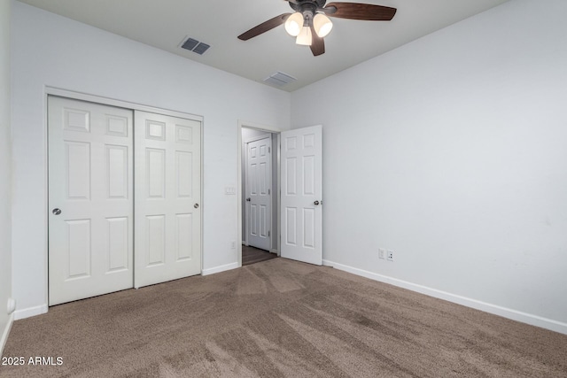 unfurnished bedroom with ceiling fan, carpet flooring, and a closet