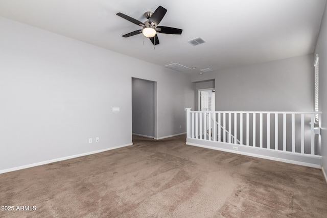 spare room featuring ceiling fan and carpet