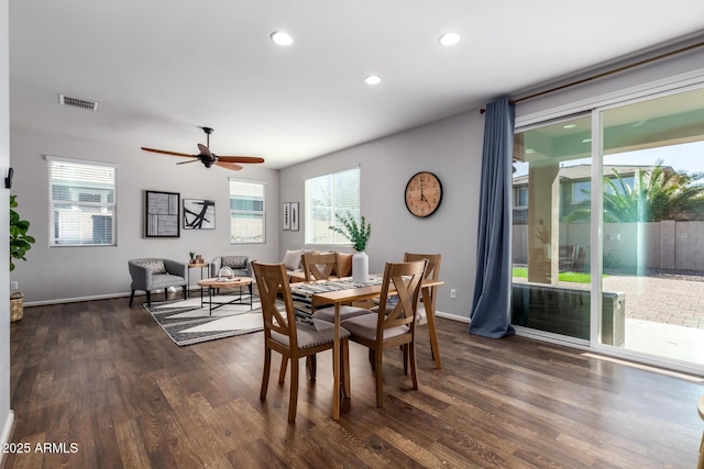 dining area featuring ceiling fan, a healthy amount of sunlight, and dark hardwood / wood-style floors