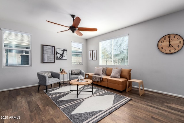 living room featuring ceiling fan and dark hardwood / wood-style floors