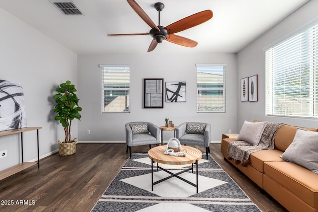 living room with ceiling fan and dark hardwood / wood-style floors