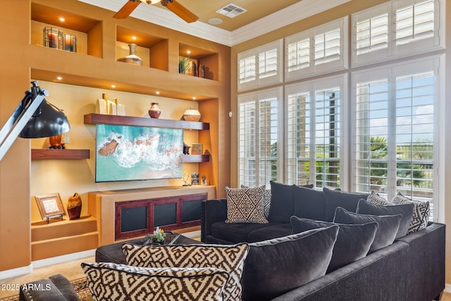 living room featuring crown molding, built in features, and ceiling fan