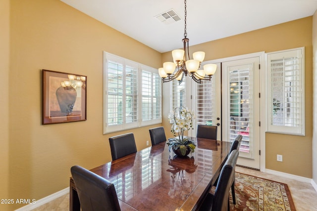 dining area featuring a notable chandelier