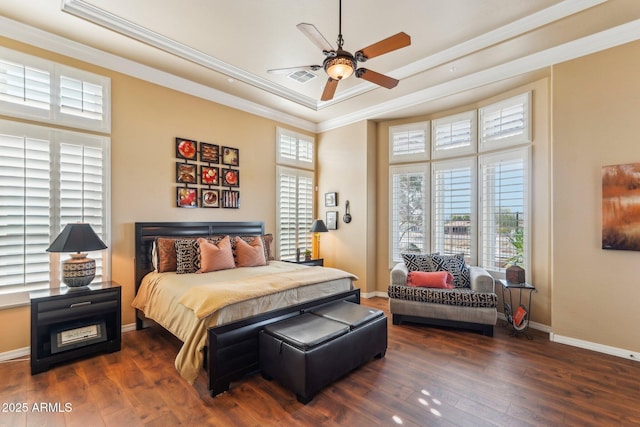 bedroom featuring a raised ceiling, ornamental molding, ceiling fan, and dark hardwood / wood-style flooring