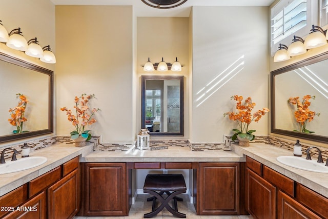 bathroom featuring vanity and backsplash