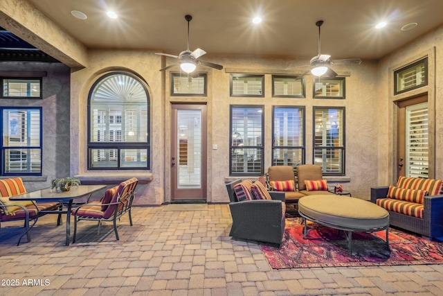 view of patio with outdoor lounge area and ceiling fan