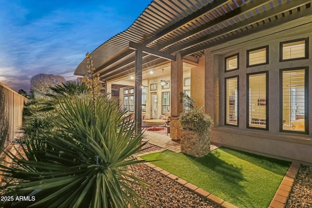 yard at dusk with a patio and a pergola