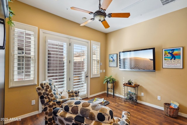 sitting room featuring dark hardwood / wood-style floors and ceiling fan