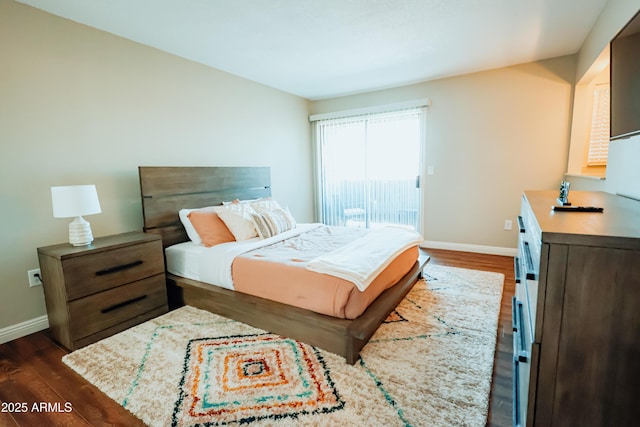 bedroom featuring dark wood finished floors, baseboards, and access to outside