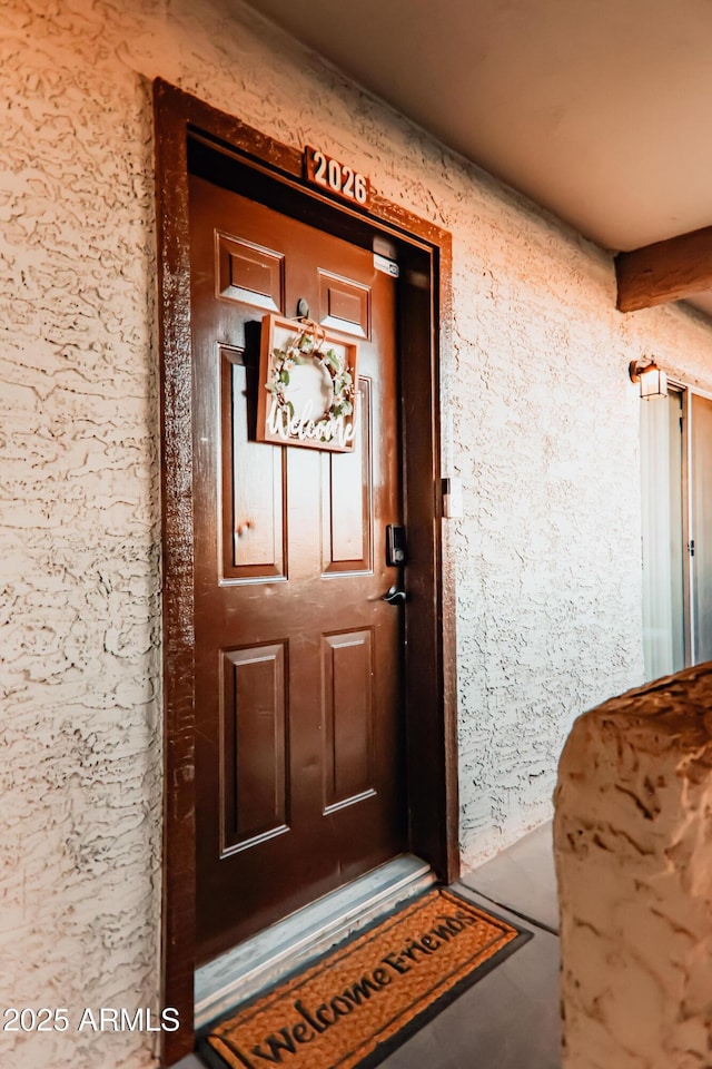 property entrance featuring stucco siding