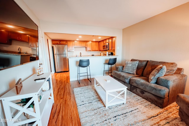 living area featuring recessed lighting and light wood-type flooring