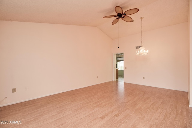 spare room with light wood-type flooring, lofted ceiling, baseboards, and ceiling fan with notable chandelier