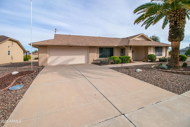 ranch-style home featuring brick siding, concrete driveway, and an attached garage