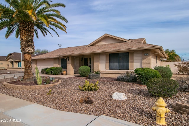 ranch-style home featuring brick siding, an attached garage, and driveway