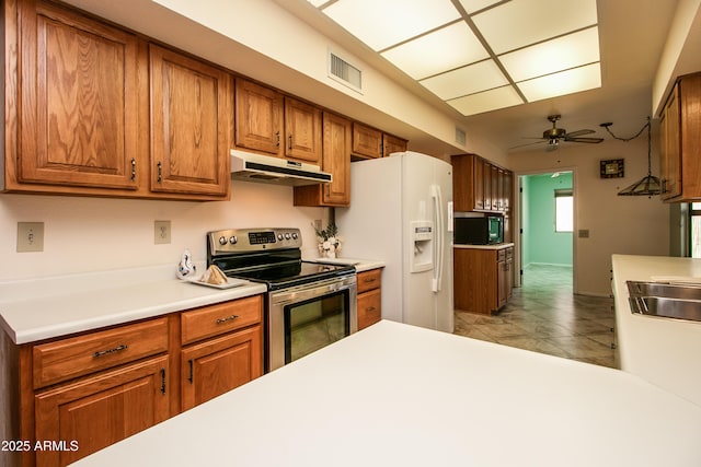 kitchen featuring visible vents, black microwave, under cabinet range hood, stainless steel electric range, and white refrigerator with ice dispenser