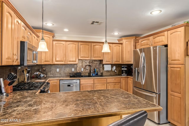 kitchen featuring tasteful backsplash, sink, decorative light fixtures, and appliances with stainless steel finishes