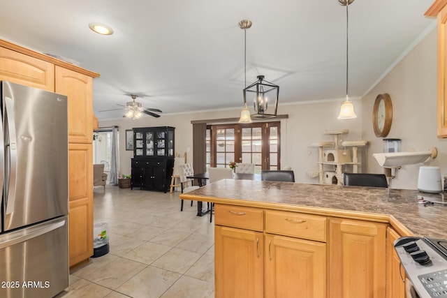 kitchen with pendant lighting, stainless steel refrigerator, ornamental molding, light brown cabinets, and french doors