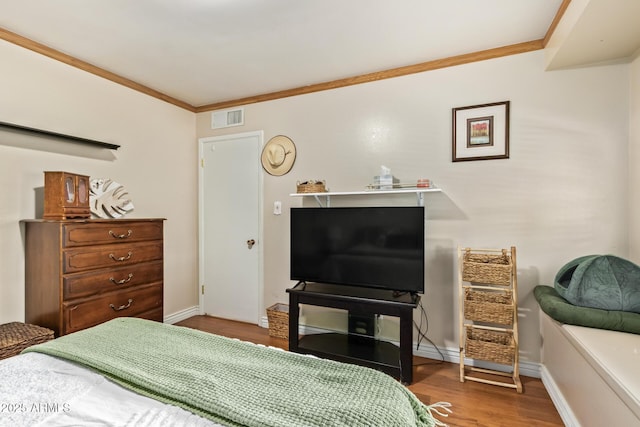 bedroom featuring crown molding and wood-type flooring