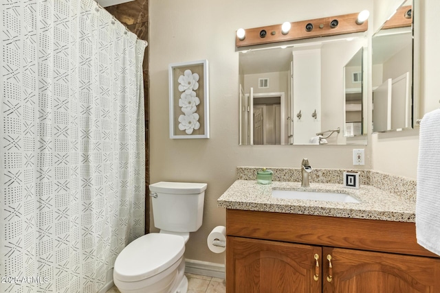 bathroom with tile patterned floors, vanity, and toilet