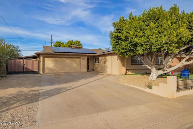 view of front of house featuring a garage and solar panels