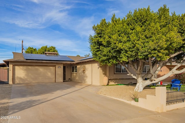 view of front of home featuring a garage and solar panels