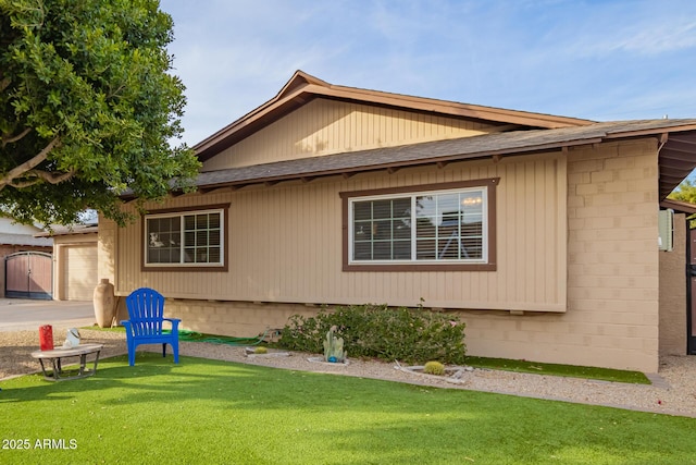 view of property exterior featuring a garage and a lawn