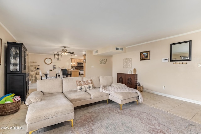 tiled living room featuring crown molding and ceiling fan