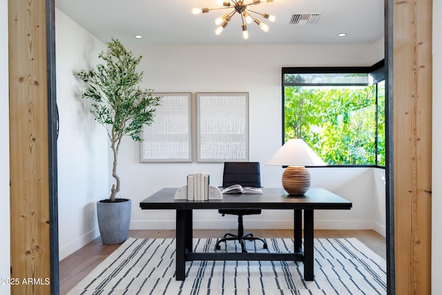 office area with an inviting chandelier and light wood-type flooring