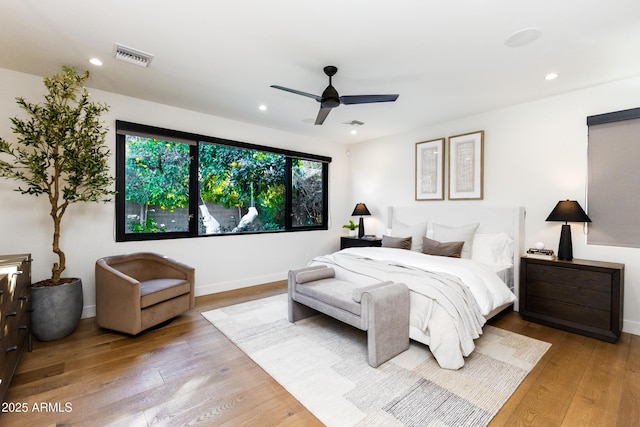 bedroom with ceiling fan and light hardwood / wood-style floors