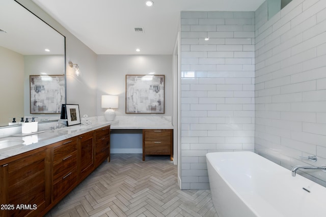 bathroom featuring vanity, a bath, and tile walls