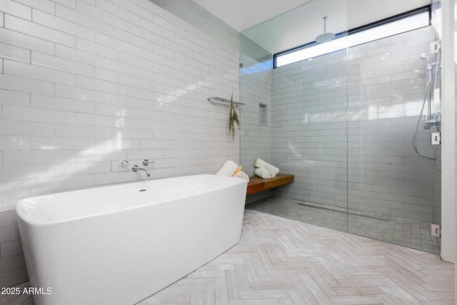 bathroom featuring separate shower and tub and tile walls