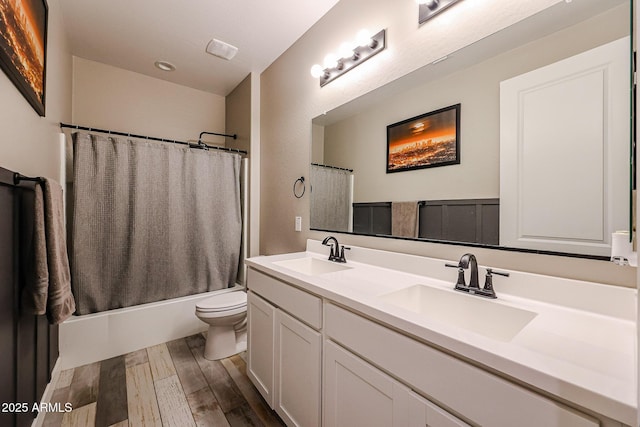 3907 S 75th Dr, Phoenix, AZ 85043 - full bathroom with double vanity, wood finished floors, toilet, and a sink
