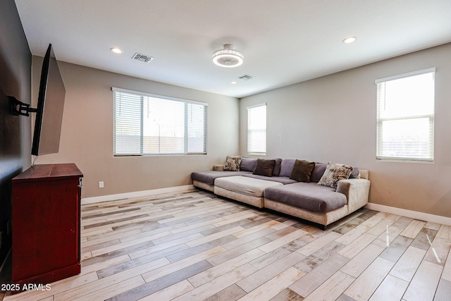 3907 S 75th Dr, Phoenix, AZ 85043 - living room featuring light wood-type flooring, visible vents, and baseboards