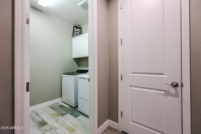 3907 S 75th Dr, Phoenix, AZ 85043 - clothes washing area featuring visible vents, light wood-style floors, baseboards, washer and dryer, and cabinet space