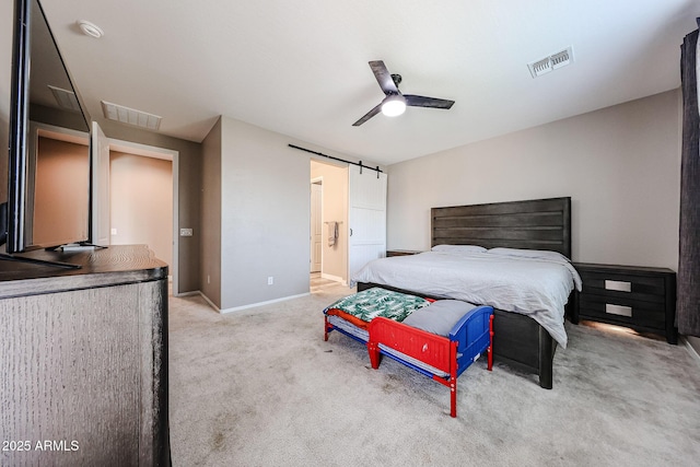 3907 S 75th Dr, Phoenix, AZ 85043 - bedroom featuring a barn door, carpet, visible vents, and baseboards