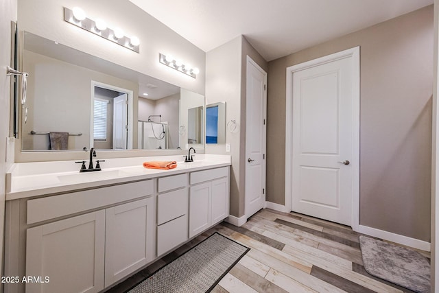 3907 S 75th Dr, Phoenix, AZ 85043 - full bath with baseboards, wood finished floors, a sink, and double vanity