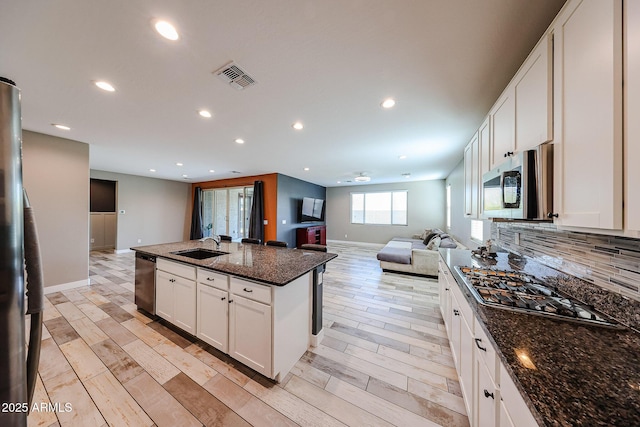 3907 S 75th Dr, Phoenix, AZ 85043 - kitchen with open floor plan, light wood-style flooring, stainless steel appliances, and recessed lighting