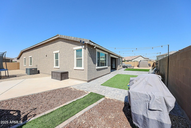 3907 S 75th Dr, Phoenix, AZ 85043 - back of house featuring a patio area, a storage shed, a fenced backyard, cooling unit, and stucco siding