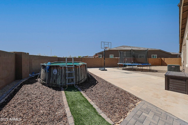 3907 S 75th Dr, Phoenix, AZ 85043 - view of yard with a fenced backyard, a patio area, a fenced in pool, and a trampoline