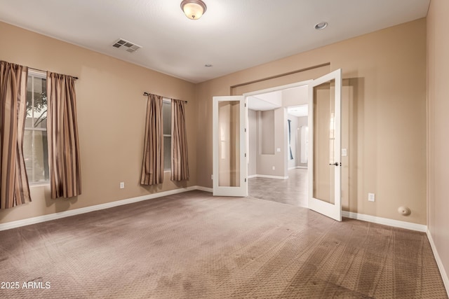 unfurnished room featuring carpet flooring and french doors