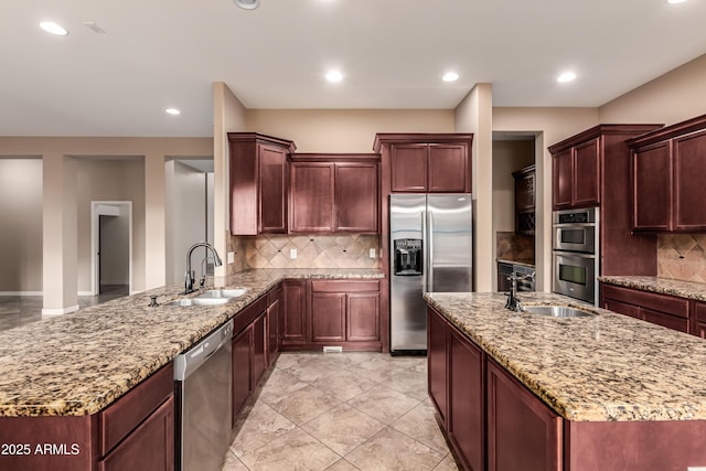 kitchen featuring decorative backsplash, sink, and appliances with stainless steel finishes