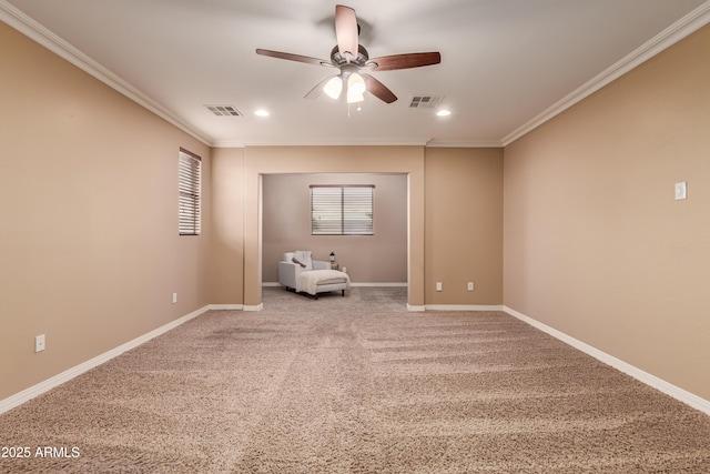 unfurnished room with carpet flooring, crown molding, and ceiling fan