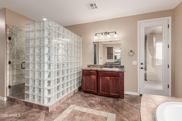 bathroom featuring vanity and independent shower and bath