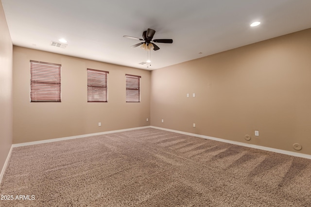 spare room featuring carpet flooring and ceiling fan