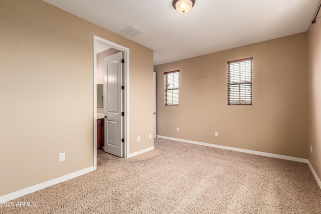 unfurnished room with light colored carpet