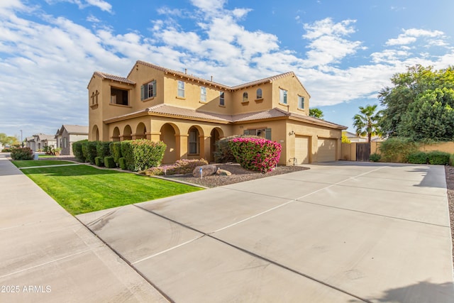 mediterranean / spanish-style home with a front yard and a garage