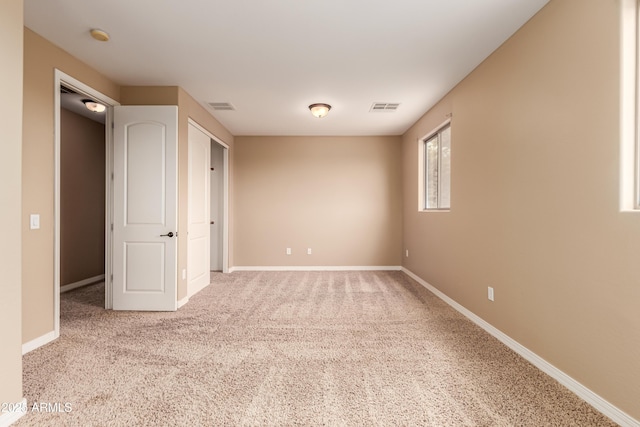 unfurnished bedroom featuring light carpet