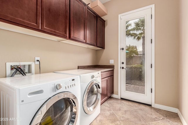 washroom featuring separate washer and dryer and cabinets