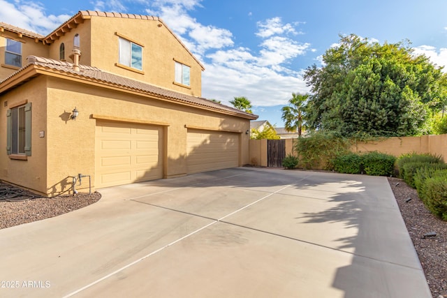 view of side of home featuring a garage